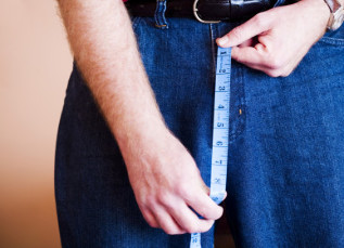 A man holding a tape measure